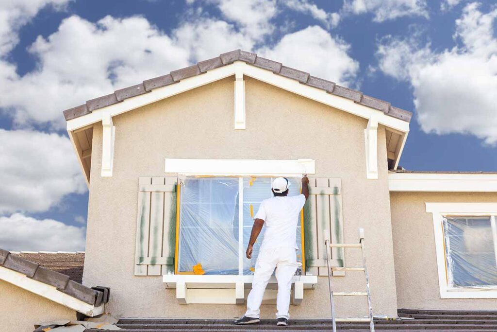 man-painting-exterior-of-house